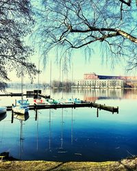 Sailboats moored in lake against sky