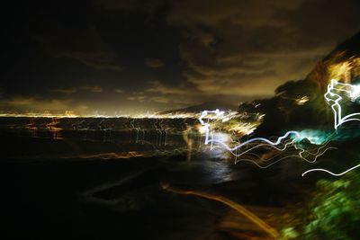 Close-up of illuminated city against sky at night