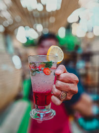 Cropped hand holding drink