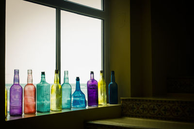 Empty bottles by window