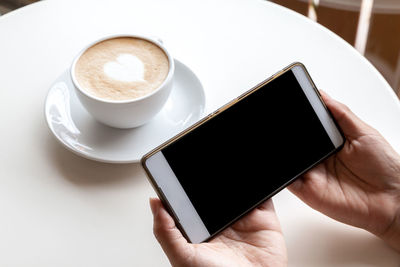 High angle view of coffee cup on table