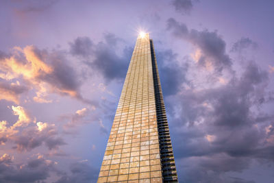 Low angle view of building against cloudy sky