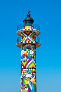 Low angle view of lighthouse against clear blue sky