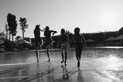 Silhouette people enjoying at amusement park
