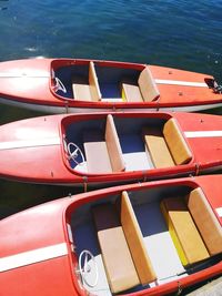 Close-up of red boats moored in water