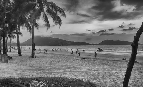 People on beach against sky