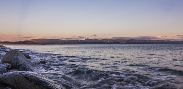 Scenic view of sea against clear sky during sunset