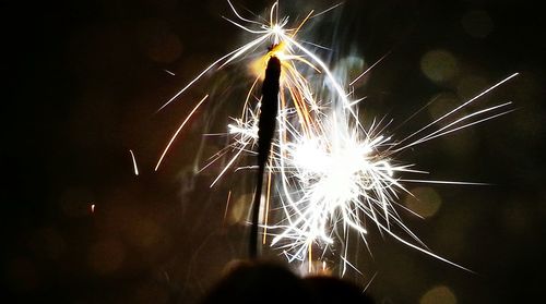 Low angle view of firework display at night