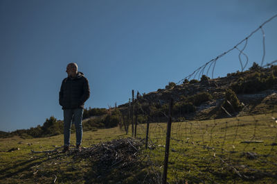 Portrait of adult man with wire fence in field. in guadalajara, castilla la mancha, spain