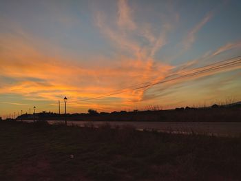 Scenic view of field against sky during sunset