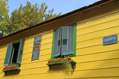 Low angle view of yellow building against sky