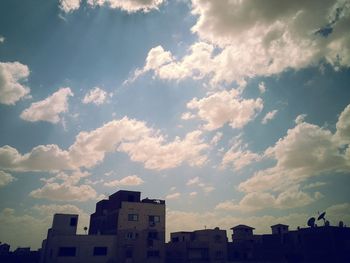 Low angle view of building against cloudy sky