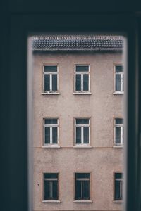 Looking out of the window on other windows low angle view of building