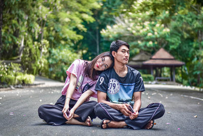 Young couple sitting in park