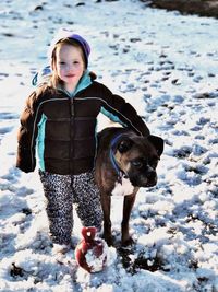 Portrait of dog standing on snow