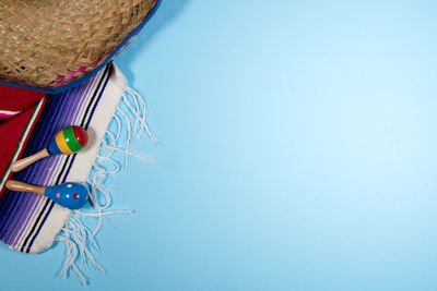 Close-up of multi colored hat hanging against blue background