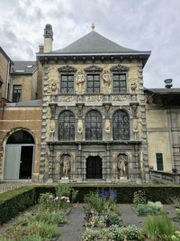 Facade of historic temple against sky