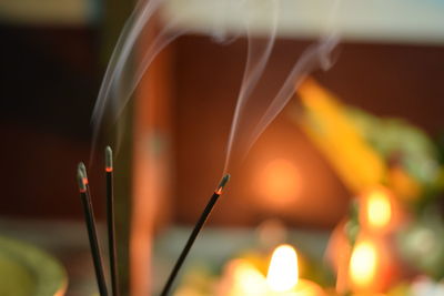 Close-up of incenses burning