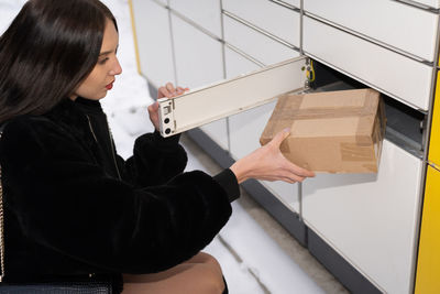 Side view of young woman working at home