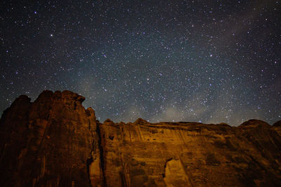 Scenic view of rock formations against sky at night