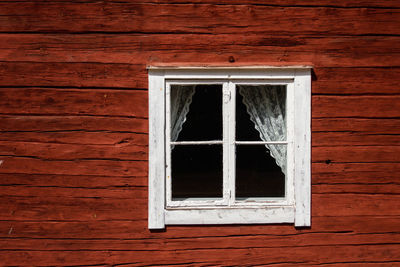 Full frame shot of window on wooden wall of building