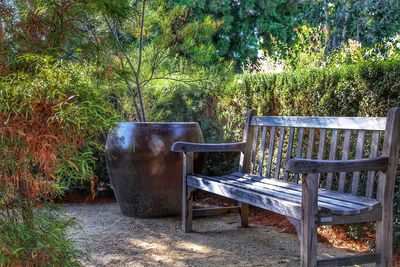 Empty chairs and table in yard