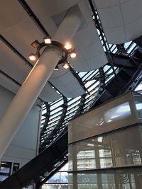 Low angle view of illuminated pendant lights hanging from ceiling