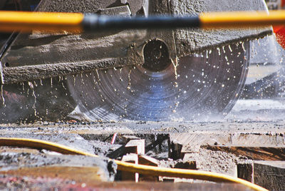 Steel saw cutting the the side walk on a construction site. 