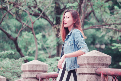 Portrait of beautiful young woman looking away