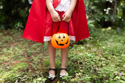 Little girl in costume of red hat in the park. happy halloween concept. high quality photo