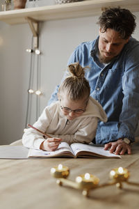 Father and son sitting in a room