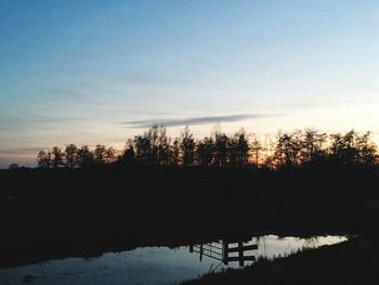 Silhouette trees against sky during sunset