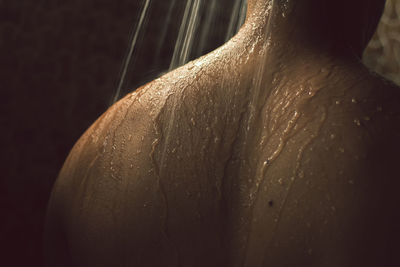Close-up of shirtless man taking bath