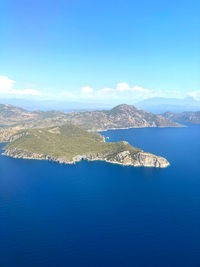 Aerial view of sea and mountains against sky