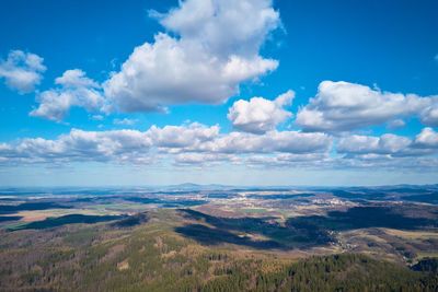 Drone flight over mountains covered with forest and valleys