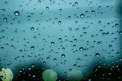 Full frame shot of raindrops on glass window