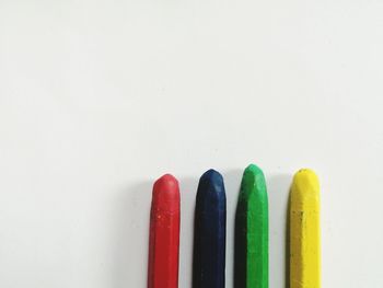 Close-up of colored pencils against white background