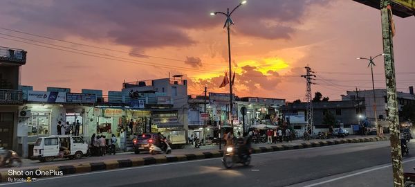 City street against sky during sunset