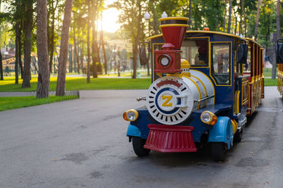 Miniature train on road at park