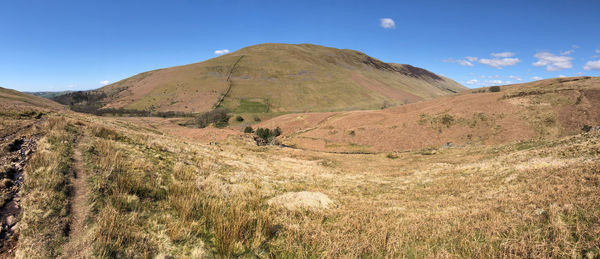 Scenic view of mountains against clear blue sky