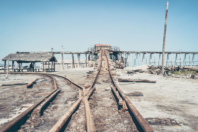 Abandoned railway bridge against clear sky during sunny day