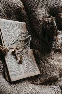 High angle view of open book on natural cloth