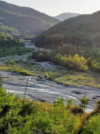 Scenic view of river amidst mountains