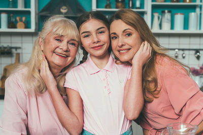 Portrait of cheerful family at kitchen