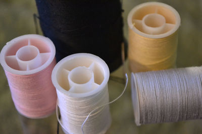 High angle view of threads in spools on table