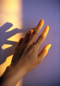 Close-up of hand on wall