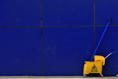 Yellow sign on blue wall