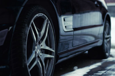 Close-up of car on street in city