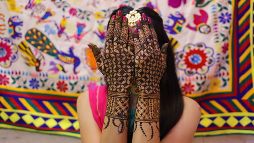 Young woman with henna tattoo during haldi ceremony