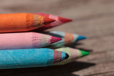 Close-up of multi colored pencils on table